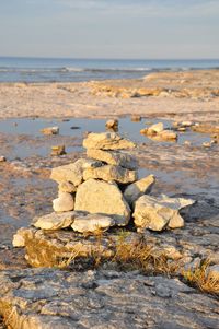 Rocks on beach against sky