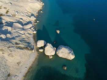 High angle view of rocks on sea shore