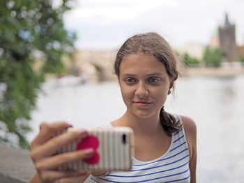 Portrait of a beautiful young woman holding water