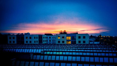 Buildings in city at sunset