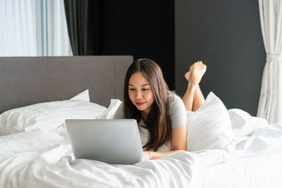 Young woman using laptop at home