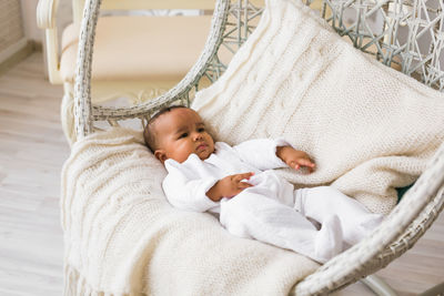 High angle view of baby sleeping on bed