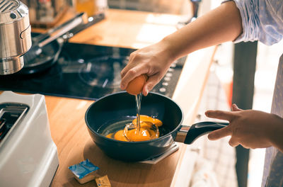 Midsection of woman preparing food in kitchen