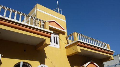 Low angle view of staircase against clear blue sky