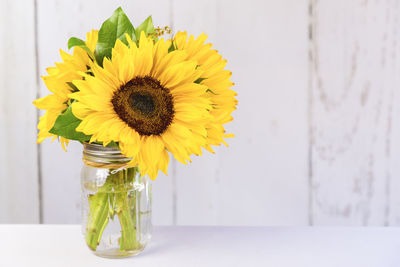 Close-up of yellow sunflower in vase on table