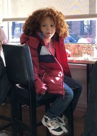 Portrait of girl sitting on chair
