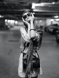 Portrait of young woman standing on street