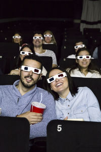 Couple with 3d glasses watching a movie in a cinema