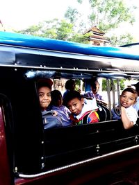 Portrait of friends sitting in car