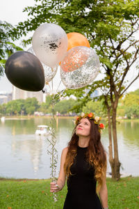 Portrait of a smiling young woman with balloons