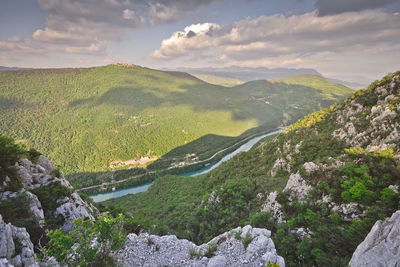 Scenic view of mountains against cloudy sky