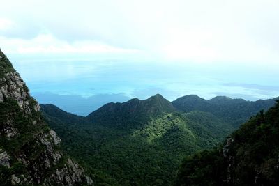 Scenic view of mountains against cloudy sky