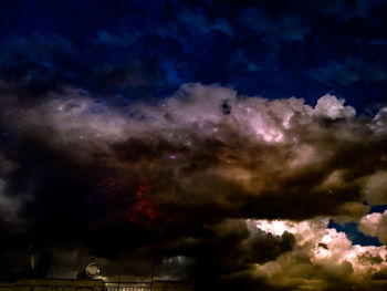 Low angle view of dramatic sky at night