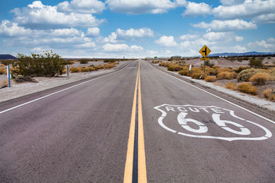 Road sign against sky