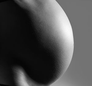 Close-up of woman against black background