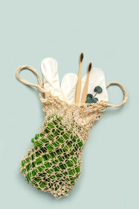 Close-up of basket on table against white background