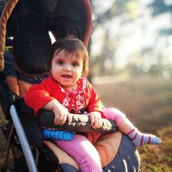 Portrait of smiling boy sitting outdoors