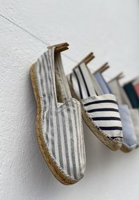 Close-up of shoes hanging against wall