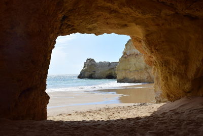 Scenic view of sea seen through cave