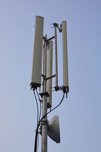 Low angle view of telephone pole against clear sky