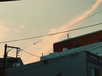 Low angle view of buildings against sky at sunset