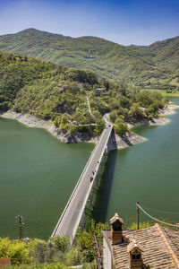 High angle view of sea and mountains against sky