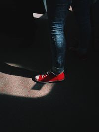 Low section of man standing on tiled floor