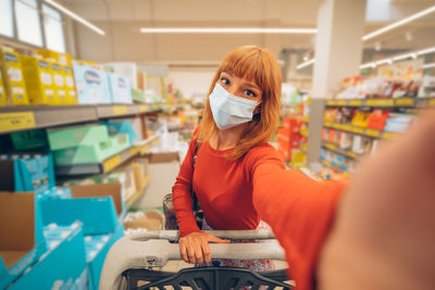 Portrait of a young woman sitting in store