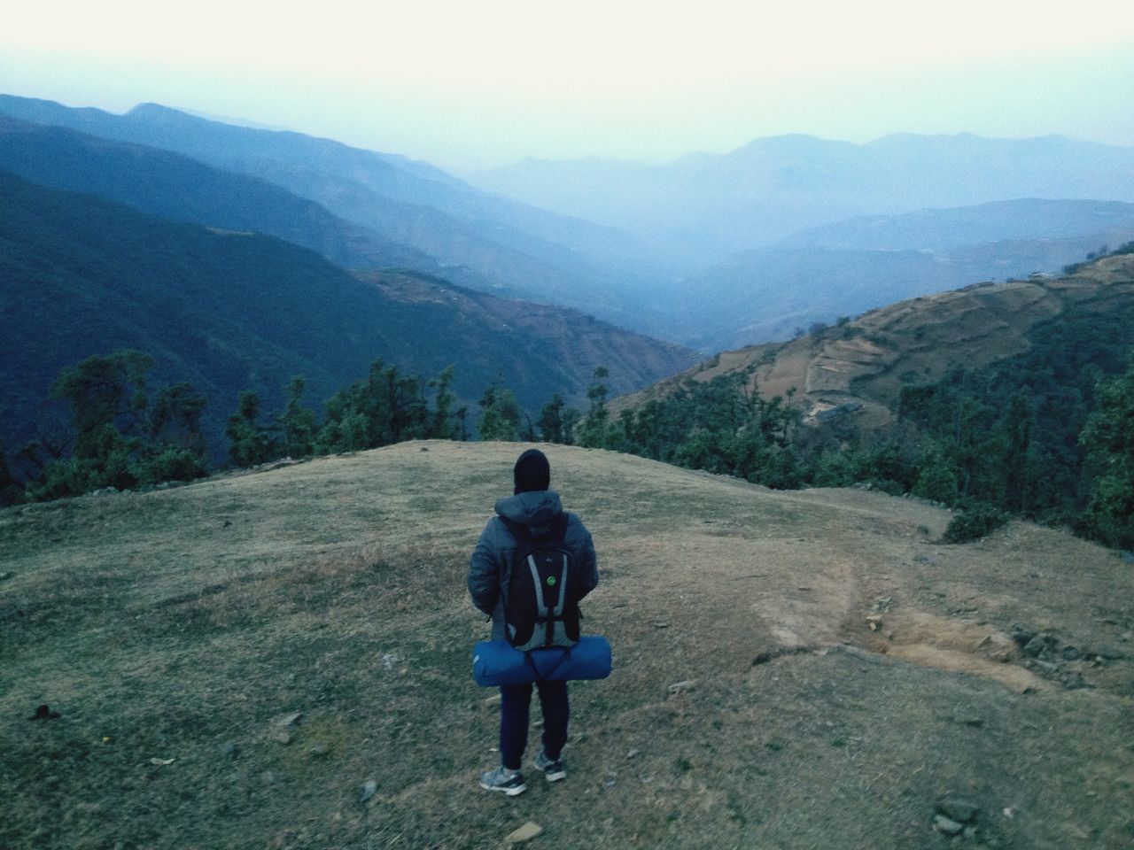 mountain, mountain range, lifestyles, rear view, leisure activity, landscape, full length, tranquil scene, tranquility, scenics, beauty in nature, casual clothing, nature, standing, non-urban scene, men, sky, hiking