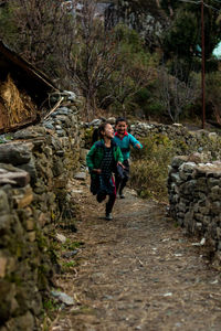 People walking on footpath in forest