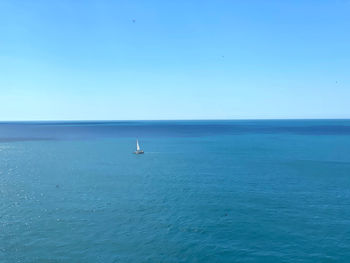 Scenic view of sea against clear blue sky