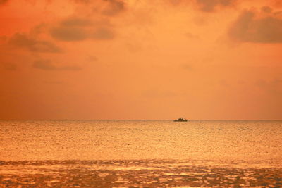 Scenic view of sea against orange sky