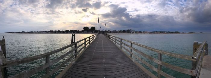 Pier over sea against sky