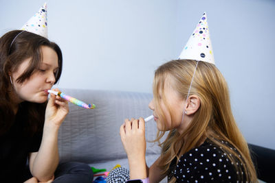 Children have fun playing, blowing up colorful balloons, at a birthday party