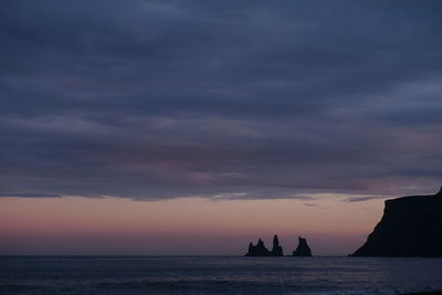 Silhouette boat in sea against sky during sunset