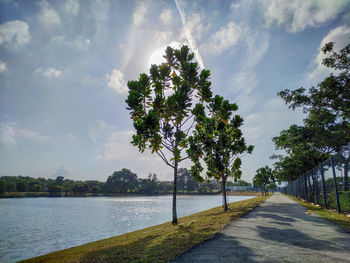 Road by river against sky