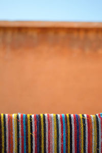 Colorful rug drying against building