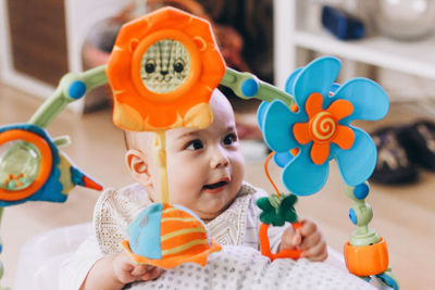 Sweet baby playing with colorful toys