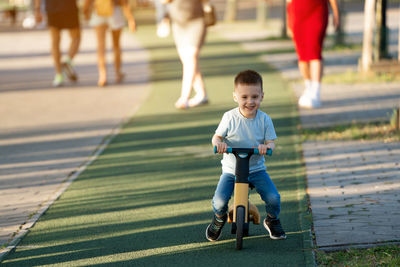 Full length of boy walking on road