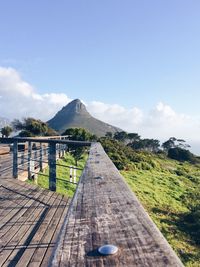 Wood paneled footbridge along countryside landscape