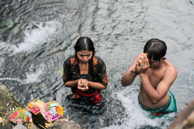 High angle view of two people sitting in water