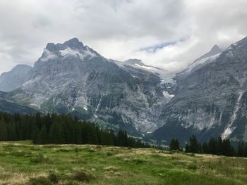 Scenic view of mountains against cloudy sky