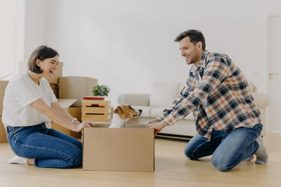 Couple sitting by box