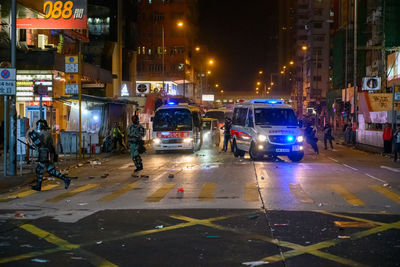Cars on city street at night