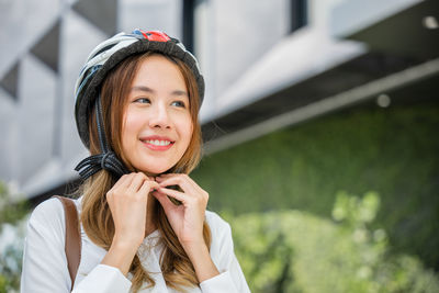 Portrait of young woman standing outdoors