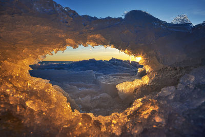 Sunset over ice arch in näsbokrok naturreservat, halland, sweden