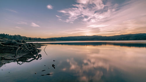 Scenic view of lake against sky during sunset