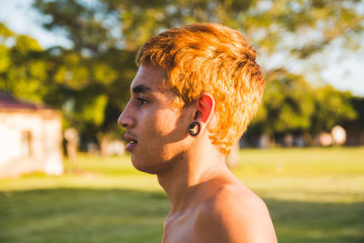 Portrait of young man looking away outdoors