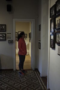 Rear view of woman standing in building