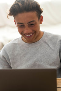 Portrait of smiling young man using mobile phone